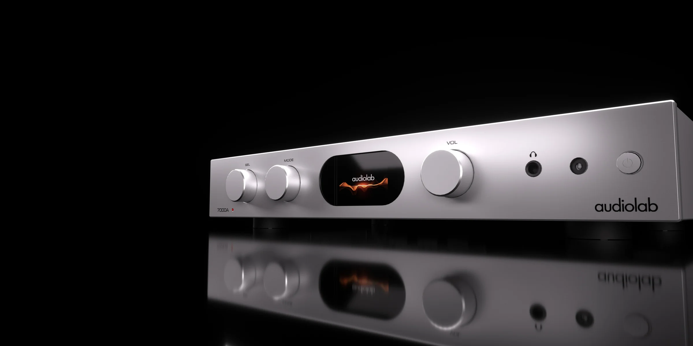 Audiolab integrated amplifier on a black reflective surface, dial and display lit