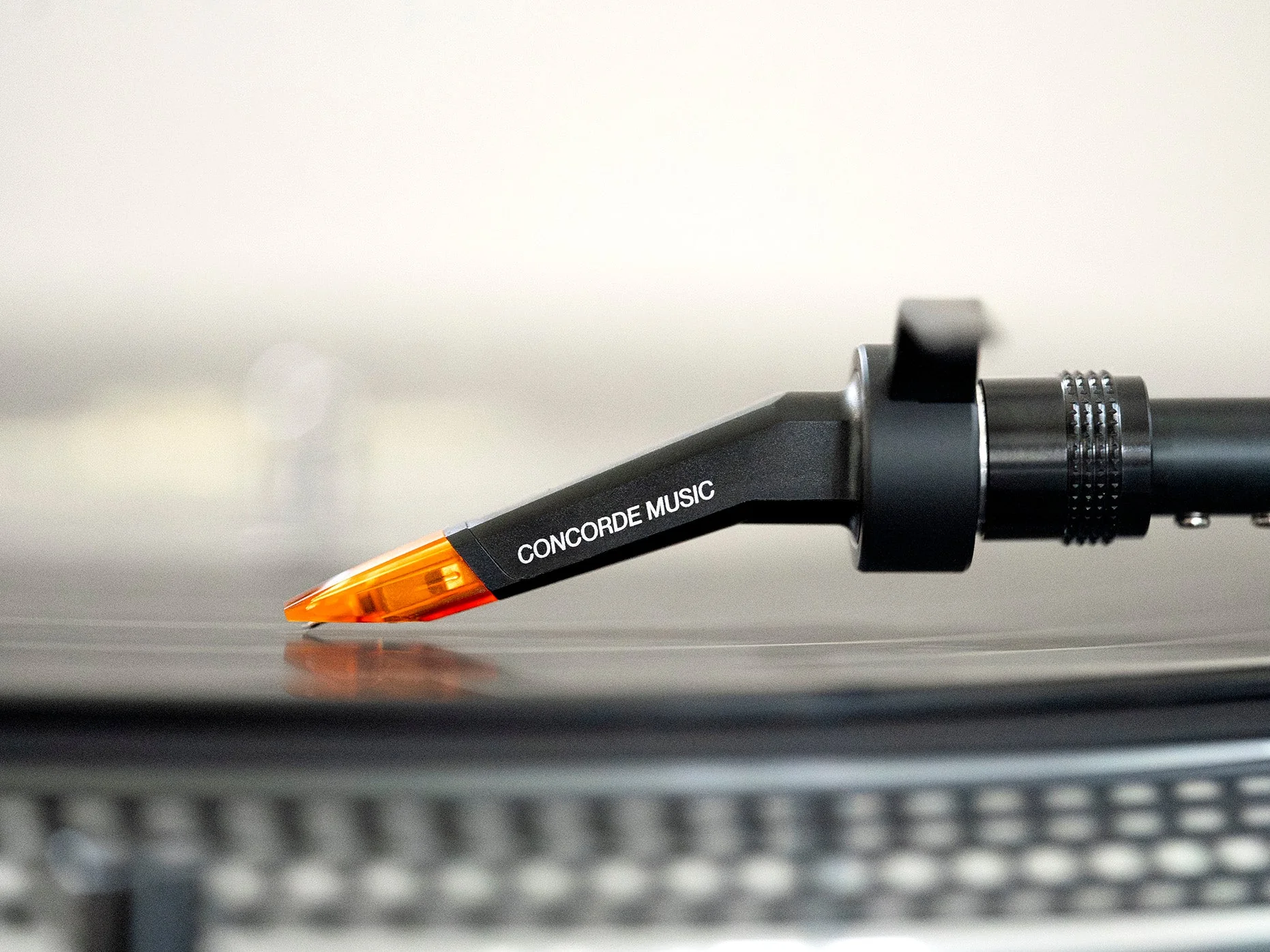 An Ortofon Concorde cartridge riding a record groove, close up