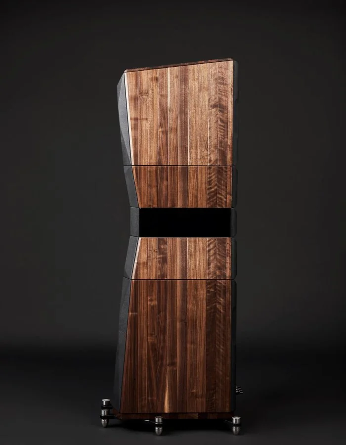 A Peak Consult floorstander in walnut against a dark ground