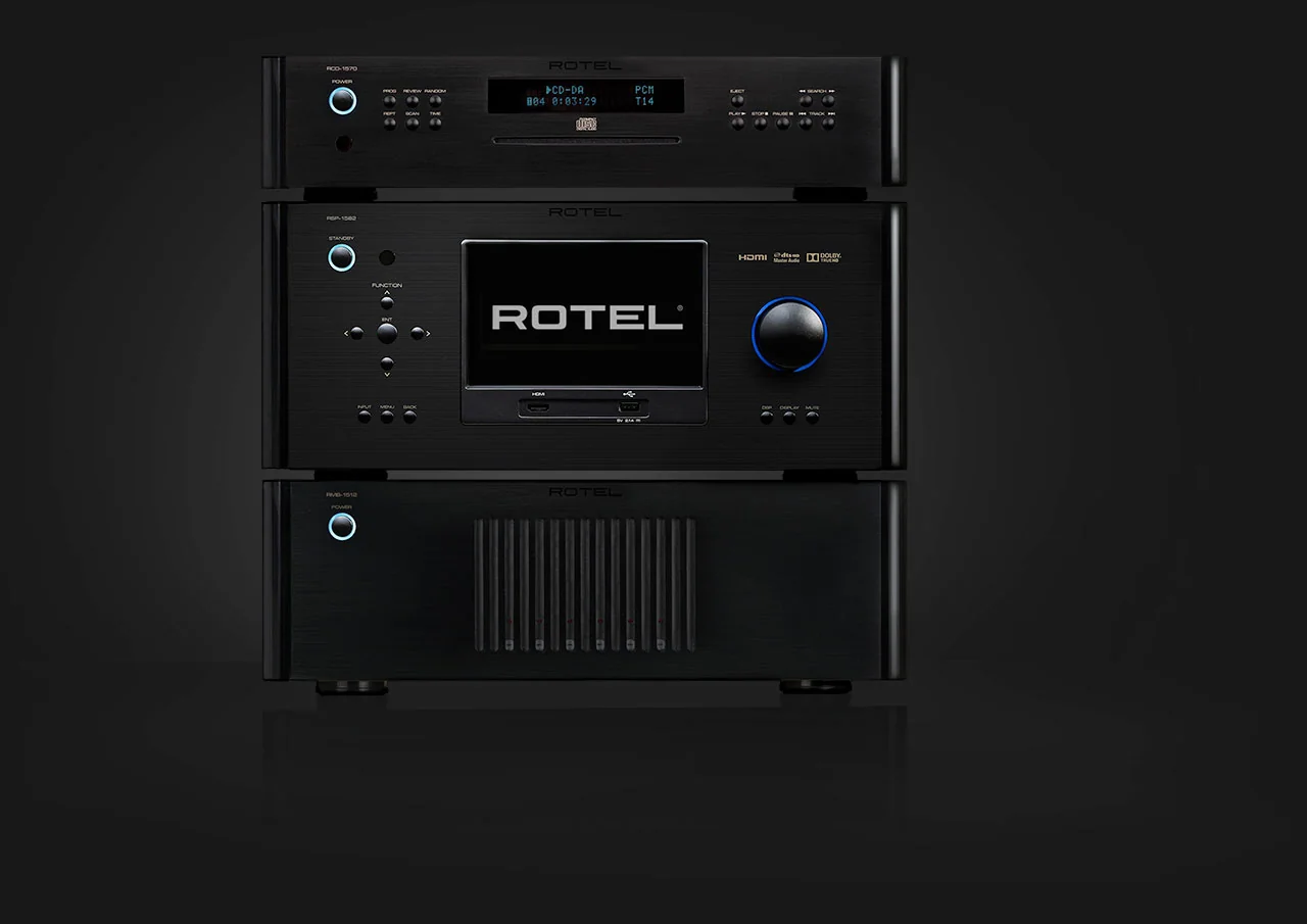 A Rotel disc player and amplifier stacked on black