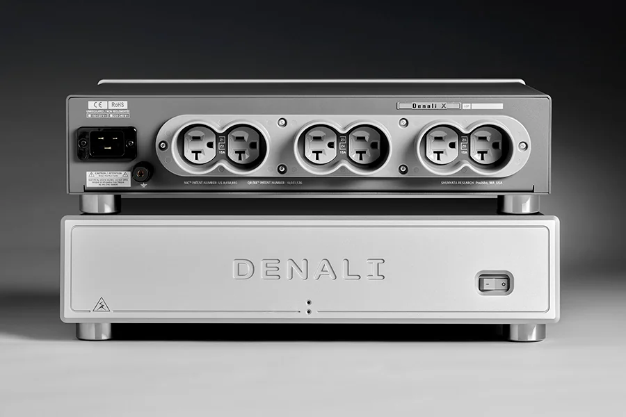 A Shunyata Denali power conditioner stacked above its distributor, silver on grey