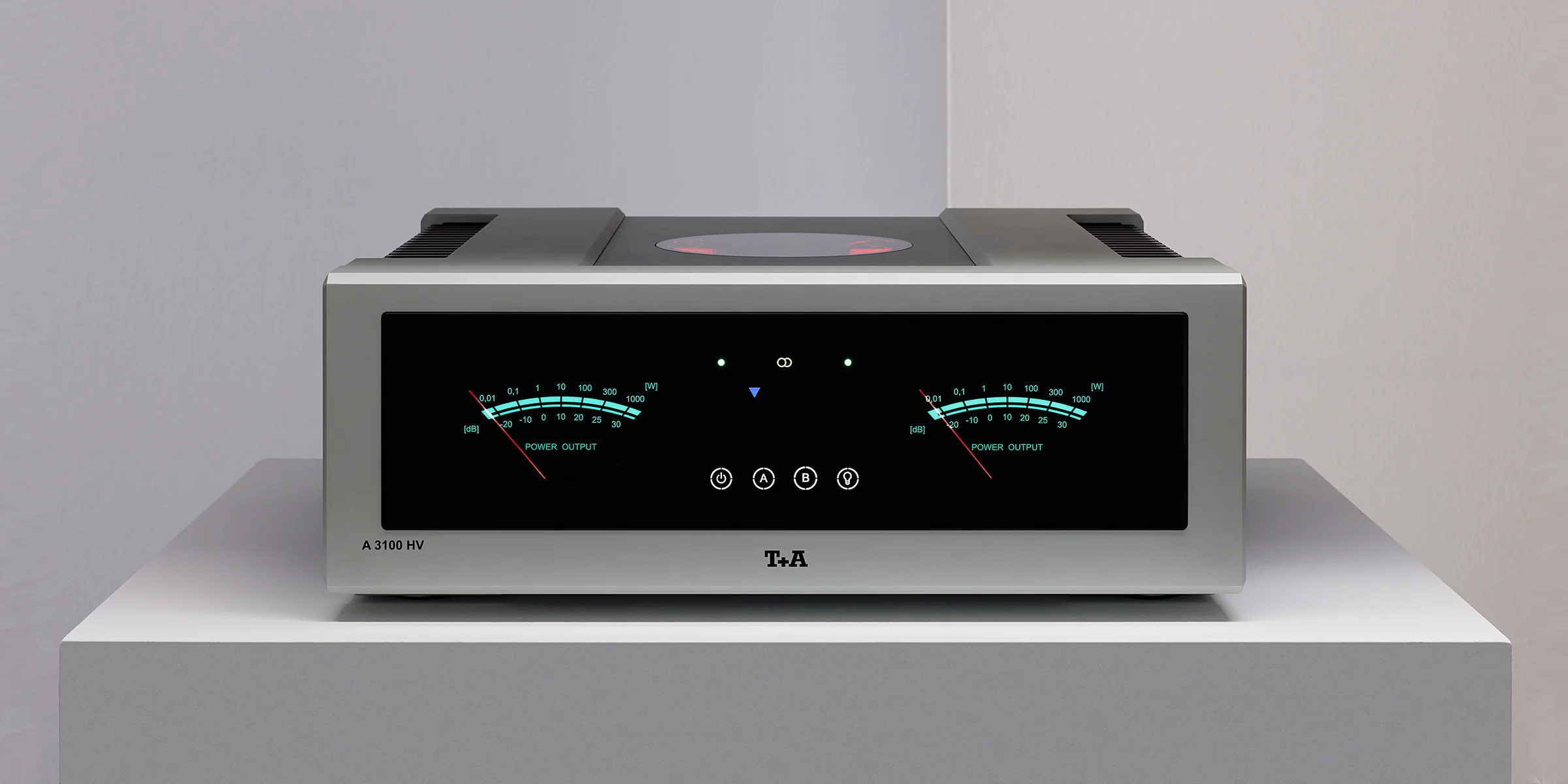 A T+A integrated amplifier in silver, twin meters in teal, on a white plinth