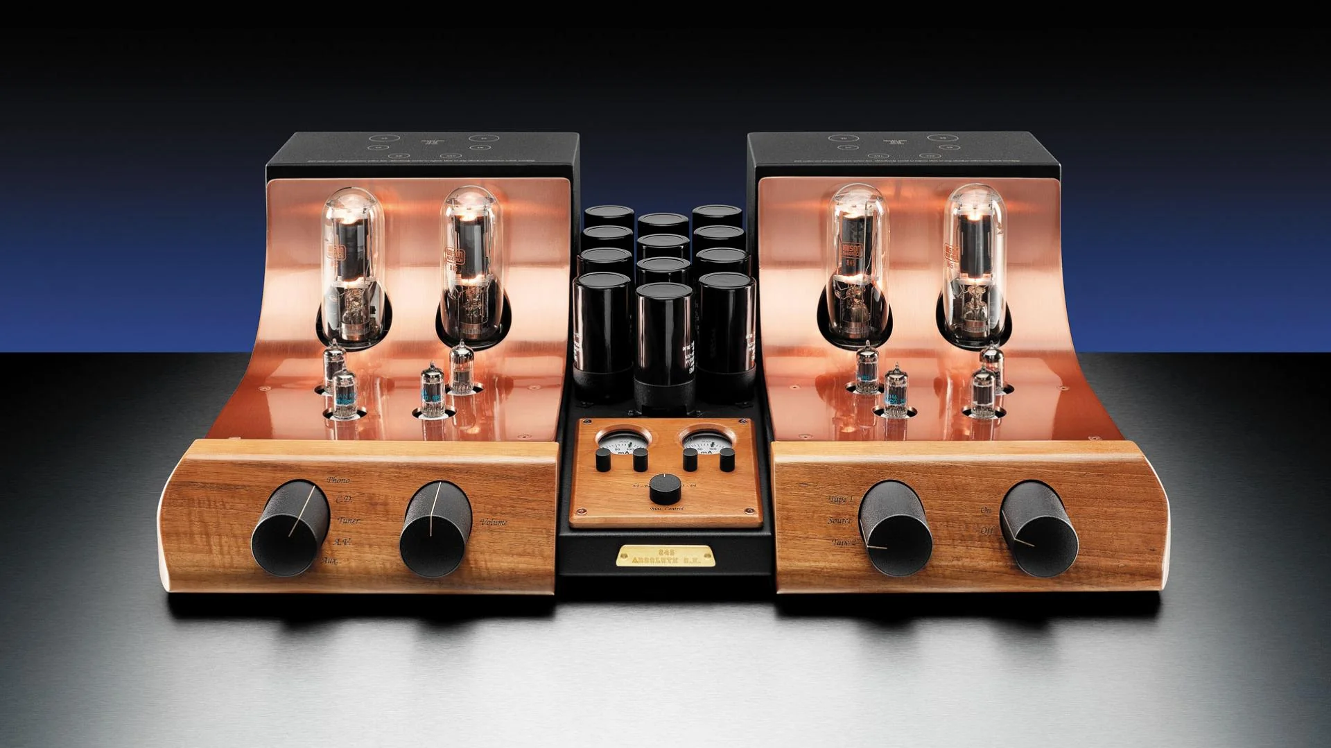 A Unison Research tube amplifier, copper plate glowing over its wooden chassis